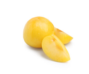 Whole and cut yellow cherry plums isolated on white