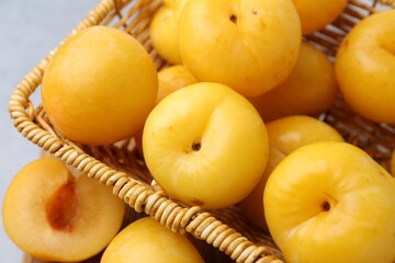 Ripe yellow cherry plums on grey table, closeup