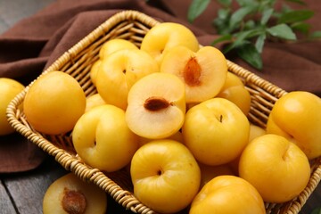 Ripe yellow cherry plums on wooden table, closeup