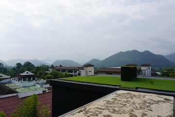 View of a city with a green roof on top of a building