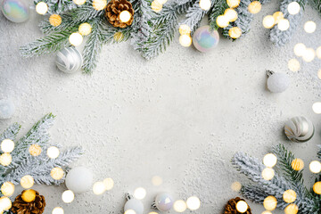 Christmas and New Year background with fir branches with holiday decorations and pine cones on a...