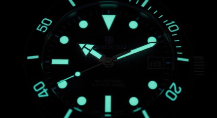 Luminous dive watch face with glow-in-the-dark markers in darkness