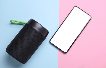 Wireless bluetooth stereo speaker with smartphone on blue pink background. Top view
