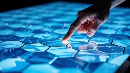 Close up of a human finger touching a glowing hexagonal digital interface with blue light and intricate network patterns creating a futuristic technology concept