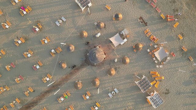 Sunrise beach Rimini Italy straw umbrellas top view
