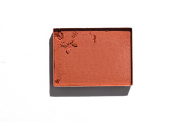 Crushed eyeshadow for makeup. Cosmetic product sample on white background. Creative layout. Beauty make concept. Top view