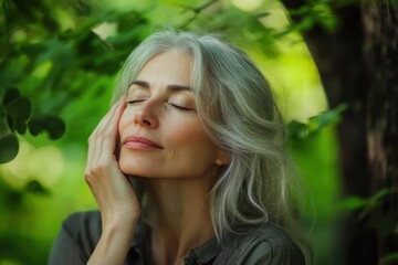 Naklejka premium Elderly woman serene in tranquil park