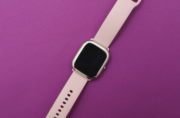 Modern smart watch bracelet on purple background
