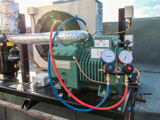 Close-up shot of a commercial refrigeration system showing detailed components and gauges.