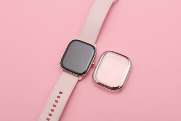 Modern smart watch and screen protector case on pink background