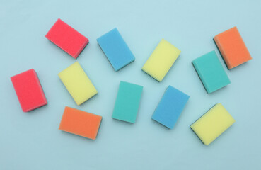 Set of colored cleaning sponges on a blue background