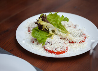 Restaurant dish tomato slices with grated cheese