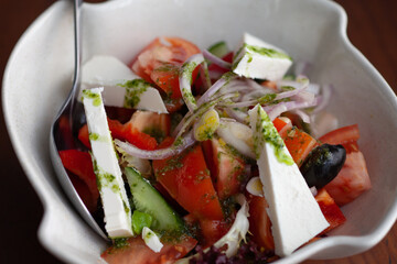Greek salad in a plate on the table
