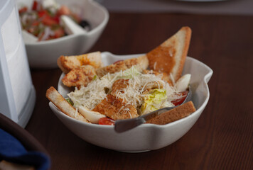 Caesar salad in a plate on the table