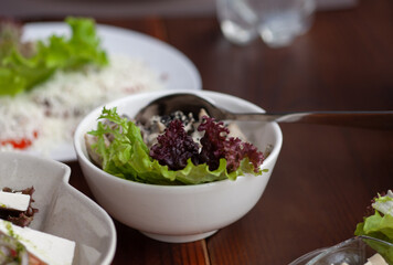 Vegetable salad on a plate among other restaurant dishes