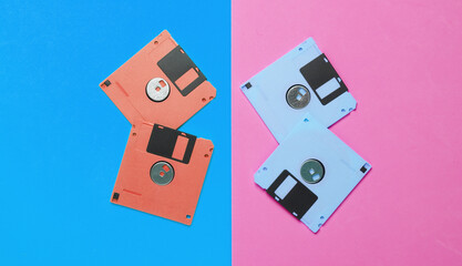 Colored floppy disks on a pink blue background. Top view