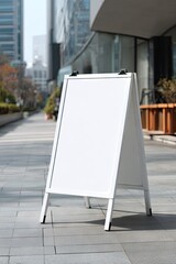 Empty white sidewalk sign, modern urban setting