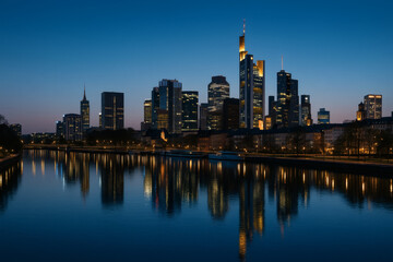 City skyline reflecting on river at dusk