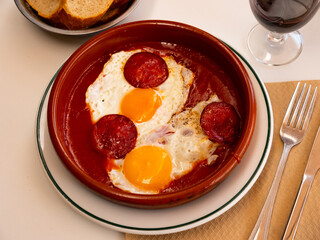 Spanish tapas with chorizo sausage and tomato paste close up