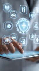 Person interacting with tablet showing shield icon and various insurance-related symbols protection