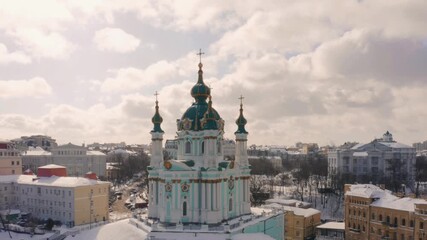 Aerial panoramic view of beautiful orthodox church and city skyline on winter day. Kyiv, Ukraine.