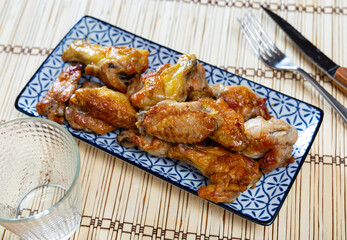 Delicious fried chicken wings served on platter