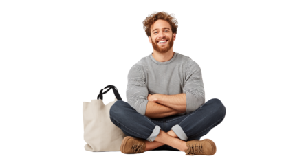 Casual male sitting cross-legged, tote bag next to him, PNG isolated
