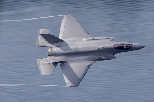 F35 fighter jet aircraft military aviation stealth fighter in flight, air force combat aircraft at low level. 
