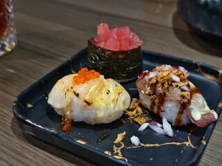 Delicious sushi nigiri selection on a black plate perfect for japanese cuisine ads