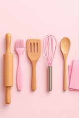 A collection of pastel pink and natural wood baking utensils arranged neatly on a light pink background