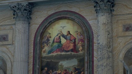 Fresco depicting coronation of Virgin Mary between Corinthian marble columns inside historic basilica