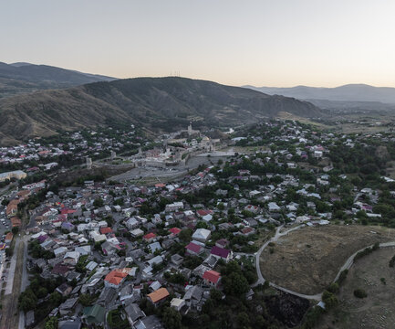 Aerial view of the historic Rabati Castle standing majestically amidst the setting sun's warm glow over the town, Akhaltsikhe, Samtskhe-Javakheti, Georgia.