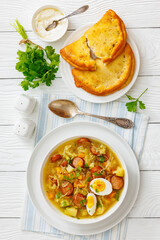 Polish sauerkraut soup with sausage in a bowl