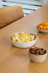 Rice millet porridge with pumpkin at the table. Breakfast 