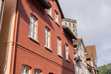 Historic red brick building with medieval stone tower and half timbered houses in Hann Münden, Germany