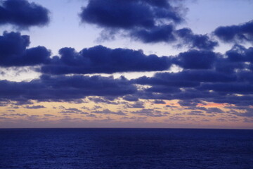 Purple clouds over the sea at sunset