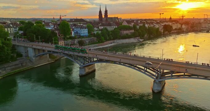 Aerial drone footage of the Basel old town along the Rhine river which contrast with modern skyscrapers in Switzerland. Shot with a forward and rotation motion. 