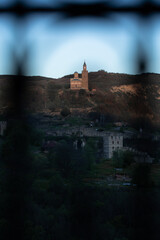 Historic Church Crowned on a Hilltop Framed by Deep Shadows