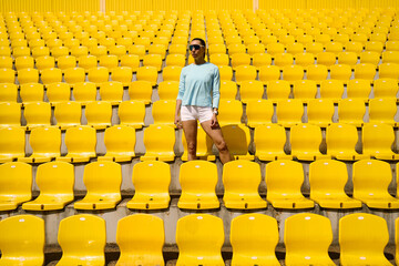 Athlete standing confidently in yellow empty stadium