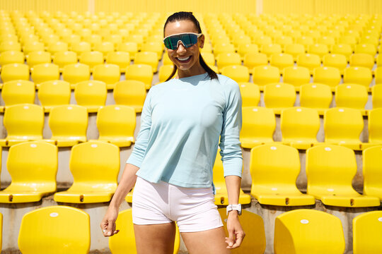 Confident athlete in an empty stadium with yellow seats