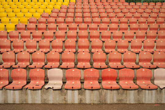 Empty colorful stadium seating in sunlight