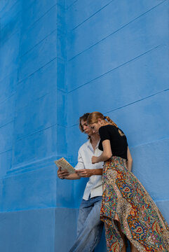 Young couple exploring a city with a map