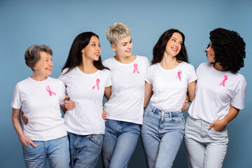 Women of different ages and ethnicities wearing pink ribbons supporting breast cancer awareness