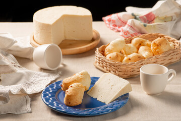 Cheese bread, table with coffee cheese bread and semi-cured cheese from Brazil, selective focus.