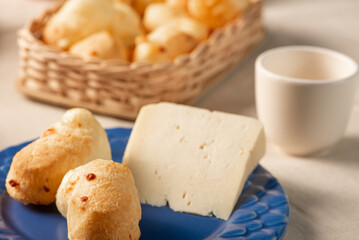 Cheese bread, table with coffee cheese bread and semi-cured cheese from Brazil, selective focus.