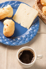 Cheese bread, table with coffee cheese bread and semi-cured cheese from Brazil, selective focus.