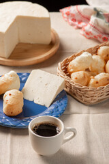 Cheese bread, table with coffee cheese bread and semi-cured cheese from Brazil, selective focus.