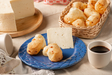 Cheese bread, table with coffee cheese bread and semi-cured cheese from Brazil, selective focus.