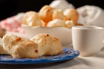 Cheese bread, table with coffee cheese bread and semi-cured cheese from Brazil, selective focus.