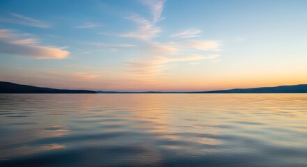 Fototapeta premium Serene lake at sunset, showcasing a tranquil water surface reflecting the colorful sky.